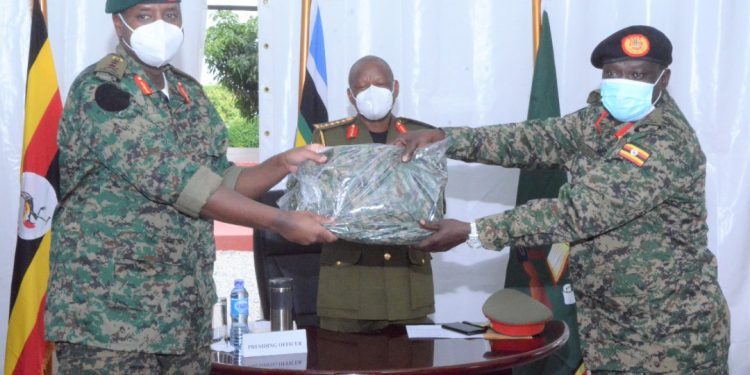 Lt Gen Muhoozi Kainerugaba the new Commandar (UPDF) Land Forces recieving the instruments of power from Maj. Gen Peter Elwelu the new Deputy Chief of Defence Forces at Bombo