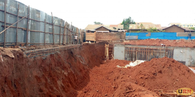 Developer Richard Munezero destroys Kamwokya houses at the Church zone because of excavation works at his construction site.